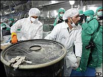 Two technicians carry a box containing yellow cake at the Iranian nuclear facility at Isfahan