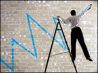 Man in suit on stepladder, painting graph on wall