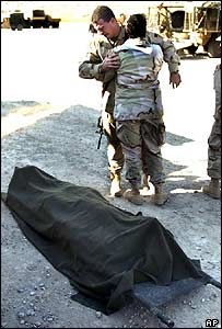 US soldier weeps near body of comrade killed in a mortar attack near Mosul in December 2004 