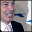 UK Prime Minister Tony Blair stands in front of the logo for the UK's presidency of the EU